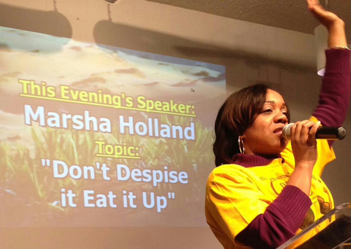 Marsha preaching beside a screen announcing her message, 'Don't Despise it Eat it Up.'
