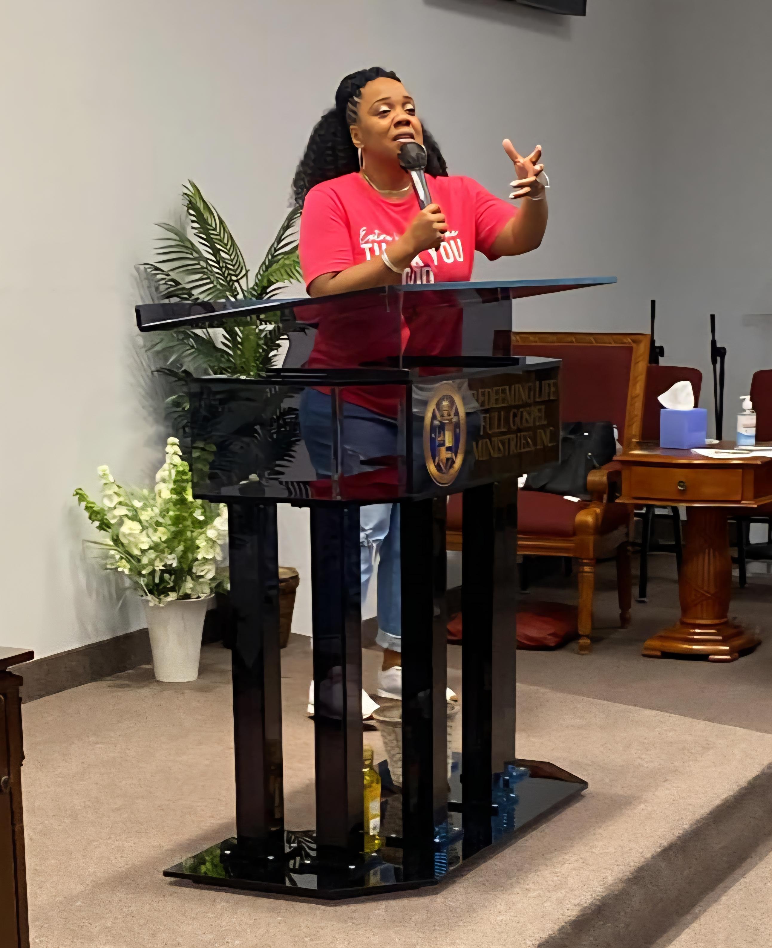 Marsha preaching from the pulpit at Redeeming Life Full Gospel Ministries.